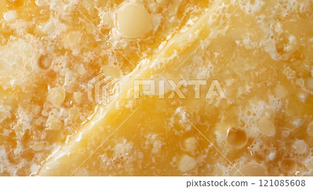 Close-Up of Melted Cheese Texture with Bubbly and Gooey Surface 121085608