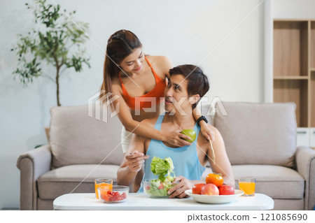 Fit Smiling couple enjoys healthy fruit breakfast. Fit Smiling couple enjoys healthy fruit breakfast. 121085690
