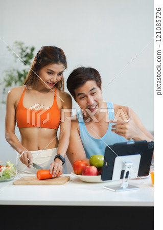 Fit Smiling couple enjoys healthy fruit breakfast. 121085726