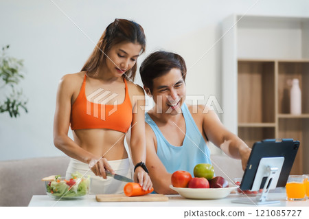 Fit Smiling couple enjoys healthy fruit breakfast. Fit Smiling couple enjoys healthy fruit breakfast. 121085727