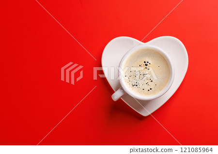 A charming coffee cup placed on a heart-shaped saucer A charming coffee cup placed on a heart-shaped saucer 121085964