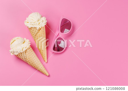 A refreshing ice cream cones set against a vibrant pink background A refreshing ice cream cones set against a vibrant pink background 121086008
