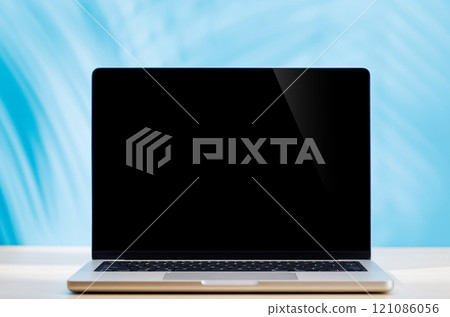 Laptop with a blank screen placed on a table Laptop with a blank screen placed on a table 121086056