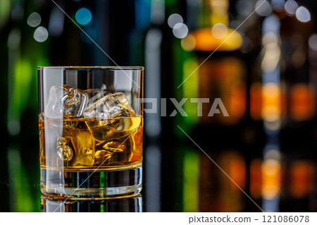Whiskey on the rocks on a bar table Whiskey on the rocks on a bar table 121086078