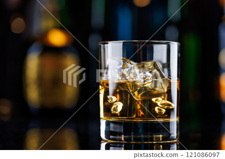 Whiskey on the rocks on a bar table Whiskey on the rocks on a bar table 121086097