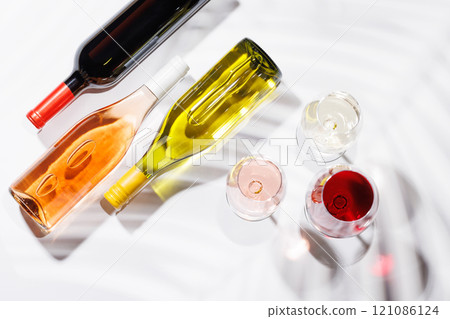 Three wine glasses filled with red, white, and rose wine Three wine glasses filled with red, white, and rose wine 121086124
