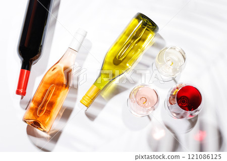 Three wine glasses filled with red, white, and rose wine Three wine glasses filled with red, white, and rose wine 121086125