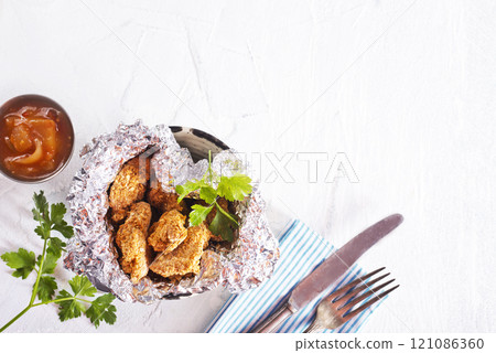 Delicious chicken nuggets on white background 121086360