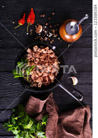 Pan fried minced meat to Italian pasta. Gray background. Top view. Pan fried minced meat to Italian pasta. Gray background. Top view. 121086384