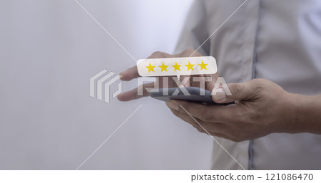 Customer Review, Young Man hand using smartphone mobile with five star to review and give 5 stars Customer Review, Young Man hand using smartphone mobile with five star to review and give 5 stars 121086470