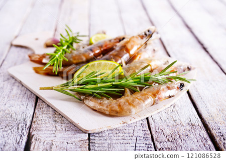 Uncooked Raw peeled tiger white shrimp prawn. Top view. Uncooked Raw peeled tiger white shrimp prawn. Top view. 121086528