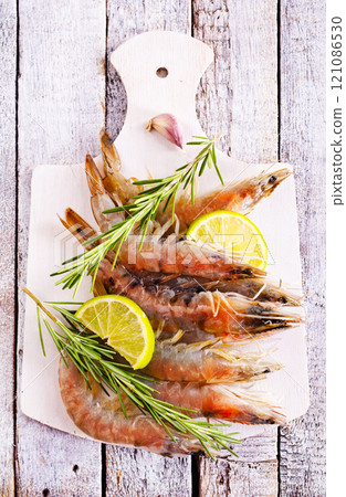 Uncooked Raw peeled tiger white shrimp prawn. Top view. Uncooked Raw peeled tiger white shrimp prawn. Top view. 121086530