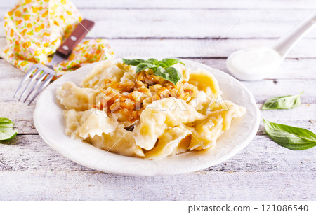 dumplings with potato on plate 121086540