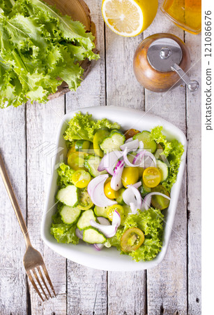 Homemade Mediterranean Cucumber Tomato Salad in a Bowl, side view. Homemade Mediterranean Cucumber Tomato Salad in a Bowl, side view. 121086676