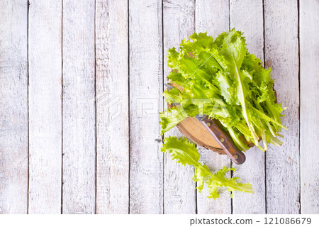 ripe organic green salad on a cutting board 121086679
