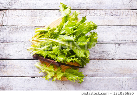 ripe organic green salad on a cutting board 121086680