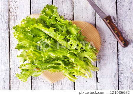 ripe organic green salad on a cutting board 121086682