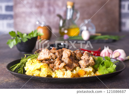 Uzbek food pilaf in iron pan. Uzbek food pilaf in iron pan. 121086687