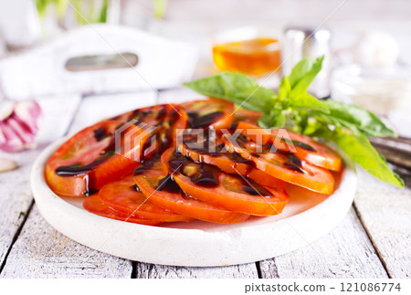 sliced tomatoes on dish with balsamic sauce sliced tomatoes on dish with balsamic sauce 121086774