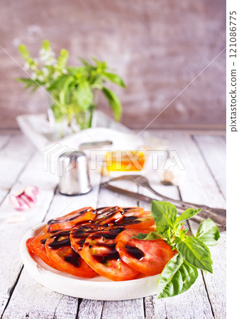 sliced tomatoes on dish with balsamic sauce sliced tomatoes on dish with balsamic sauce 121086775