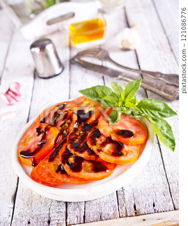 sliced tomatoes on dish with balsamic sauce sliced tomatoes on dish with balsamic sauce 121086776