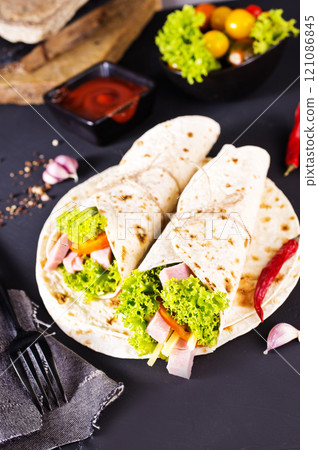 Shawarma sandwich, fresh roll of lavash (pita bread) pork shawarma with ham and cheese Shawarma sandwich, fresh roll of lavash (pita bread) pork shawarma with ham and cheese 121086845