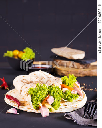 Shawarma sandwich, fresh roll of lavash (pita bread) pork shawarma with ham and cheese Shawarma sandwich, fresh roll of lavash (pita bread) pork shawarma with ham and cheese 121086846