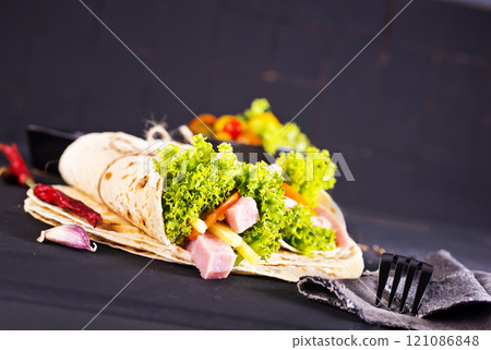 Shawarma sandwich, fresh roll of lavash (pita bread) pork shawarma with ham and cheese 121086848