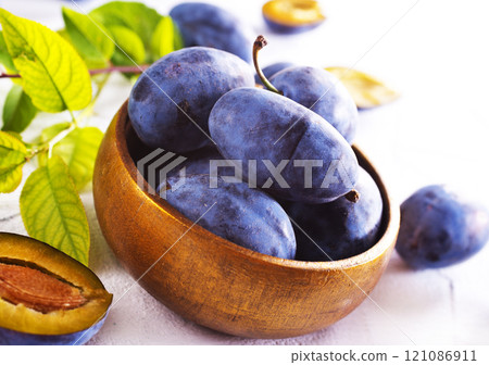 fresh ripe plums on light background fresh ripe plums on light background 121086911
