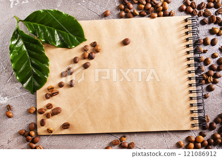 Roasted coffee beans with note on a table 121086912
