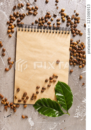 Roasted coffee beans with note on a table 121086913