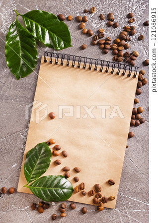 Roasted coffee beans with note on a table 121086915