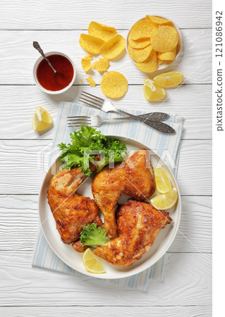baked in oven three chicken leg quarters, top view baked in oven three chicken leg quarters, top view 121086942