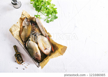 raw fish on wooden tray 121086985