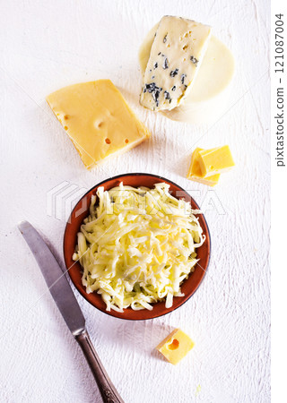 Shredded mozzarella and red cheddar cheese in bowl 121087004