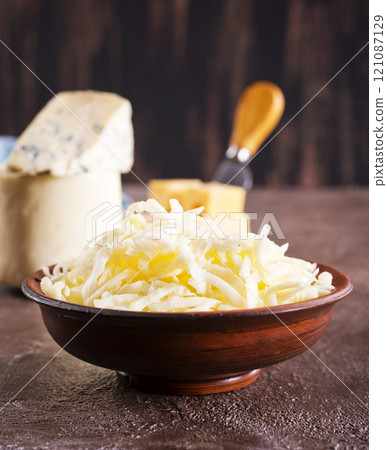 grated cheese in bowl, mix from cheese grated cheese in bowl, mix from cheese 121087129