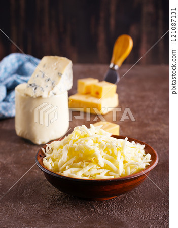 grated cheese in bowl, mix from cheese grated cheese in bowl, mix from cheese 121087131