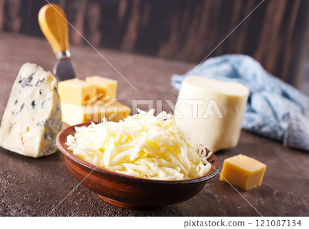 grated cheese in bowl, mix from cheese grated cheese in bowl, mix from cheese 121087134