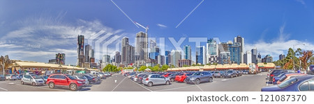 Melbourne skyline and parking lot in daylight, showcasing modern architecture and urban life Melbourne skyline and parking lot in daylight, showcasing modern architecture and urban life 121087370