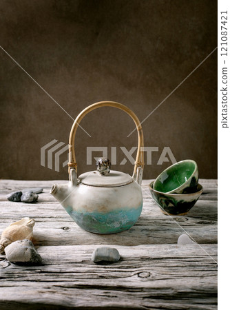 Ceramic teapot with wooden handle 121087421