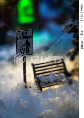 A Christmas diorama. A snow-covered bench under a street lamp A Christmas diorama. A snow-covered bench under a street lamp 121087668