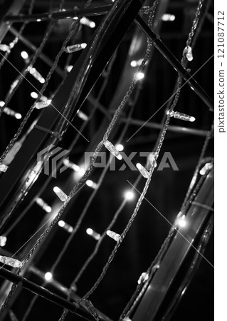 Christmas garland on the street in close-up. Black and white photo 121087712