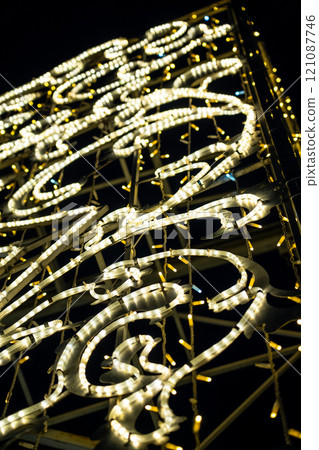 Christmas garland on the street in close-up. Yellow glow Christmas garland on the street in close-up. Yellow glow 121087746
