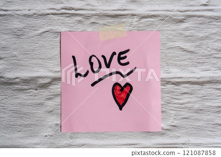 The word love written on a post-it or note. 121087858