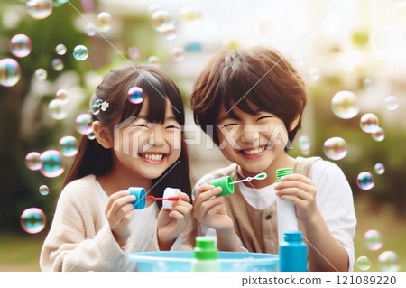 Two children playing outside with soap bubbles Two children playing outside with soap bubbles 121089220