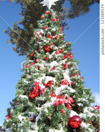 Christmas Tree with Holiday Ornaments Against a Sky Background Christmas Tree with Holiday Ornaments Against a Sky Background 121089574