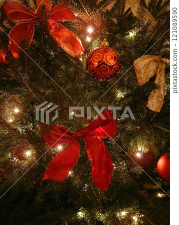 Christmas Tree with Gold Ornaments on Evergreen Branches 121089590