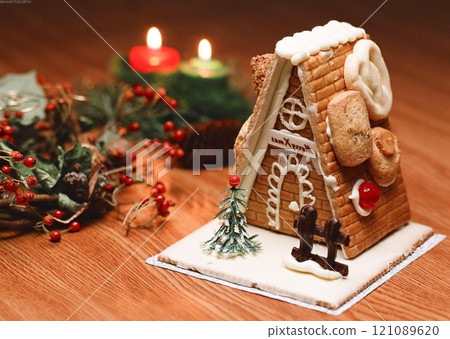 Christmas Gingerbread House Decoration with Icing on Wooden Table Christmas Gingerbread House Decoration with Icing on Wooden Table 121089620
