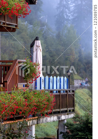 Outdoor cafe terrace in Alps, morning mist, 121089785