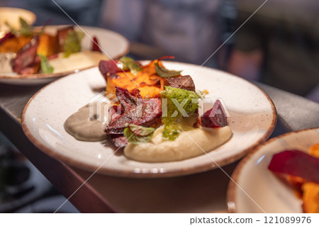 Restaurant kitchen plating elegant gourmet dishes 121089976